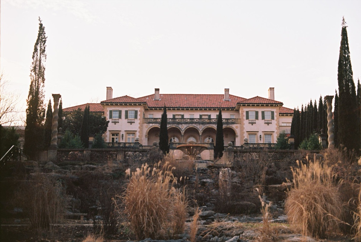southwestern mansion exterior with overgrown garden
