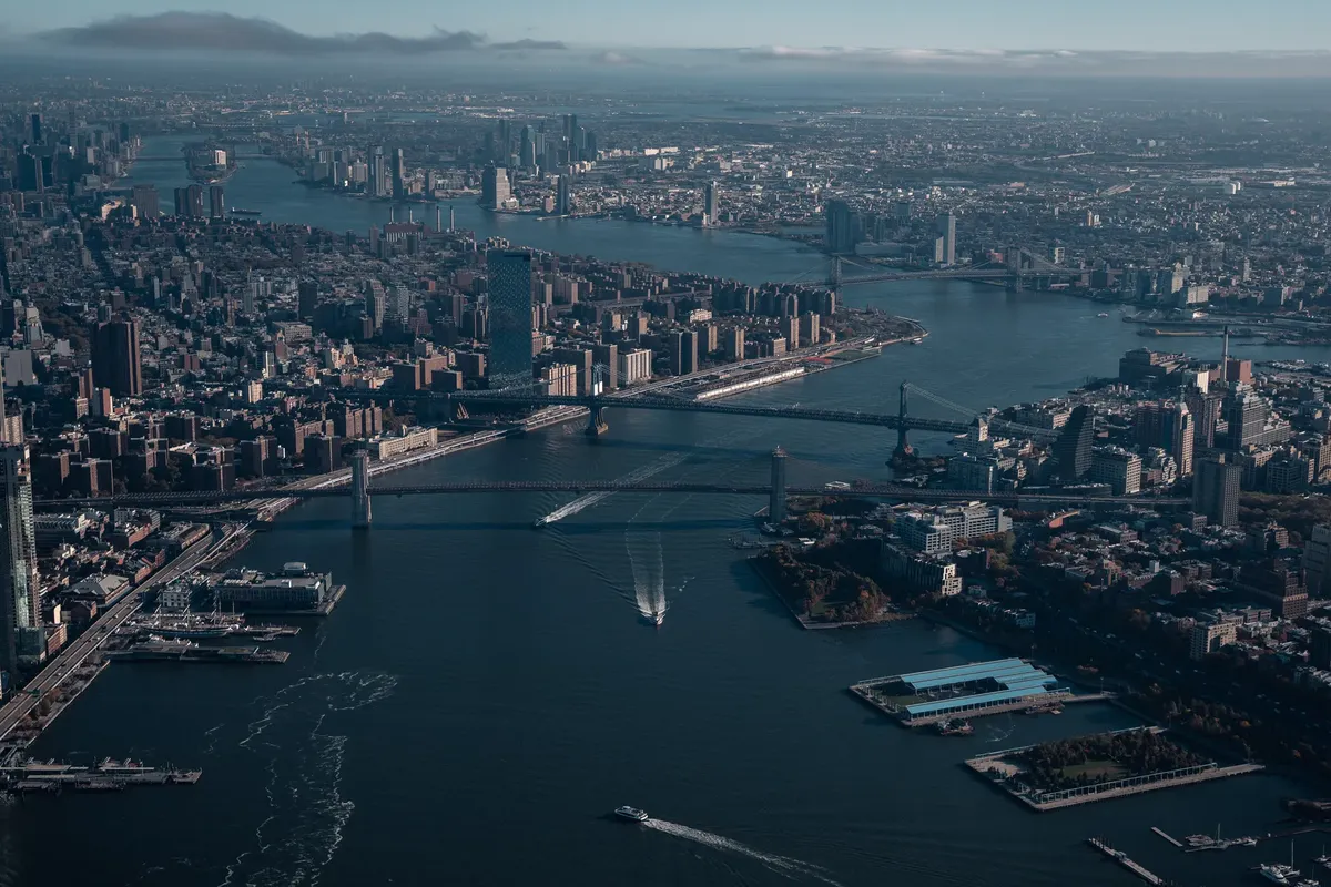 A breathtaking aerial view of New York City's iconic skyline, bridges, and river.