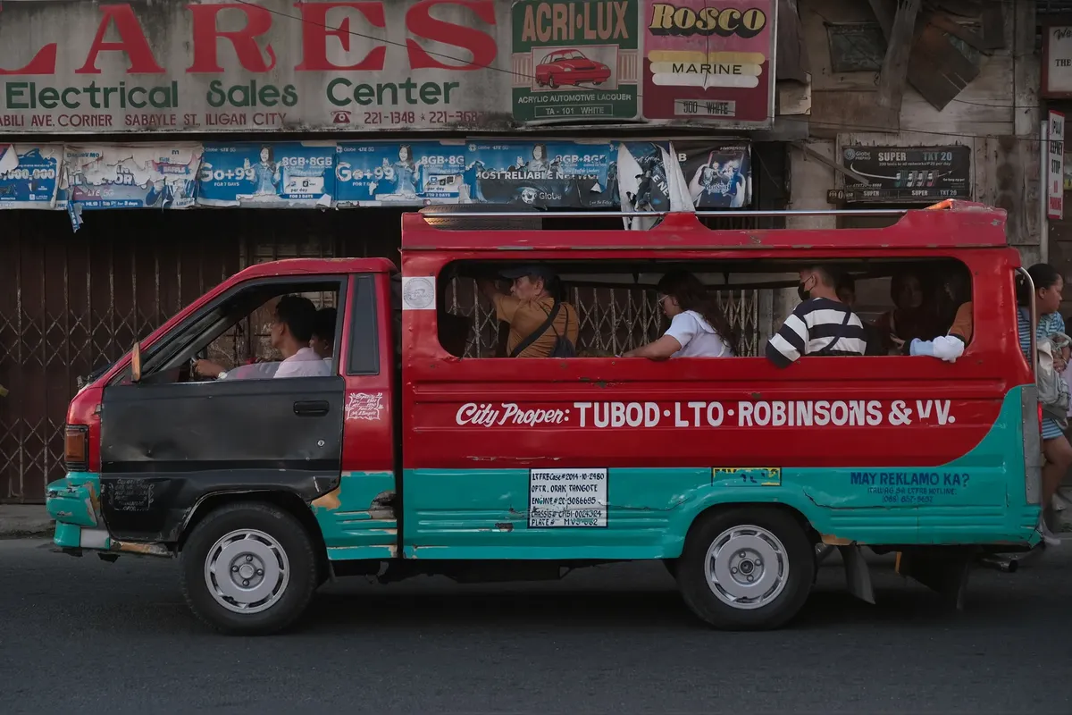 A vibrant jeepney navigates the streets of Iligan City, Northern Mindanao, with passengers.