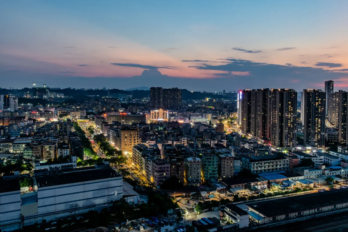 Explore a vibrant city skyline at twilight with illuminated skyscrapers and colorful skies.