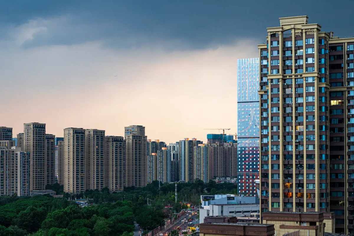 Captivating skyline view of a modern city with an array of high-rise residential and commercial buildings under a dramatic sky.
