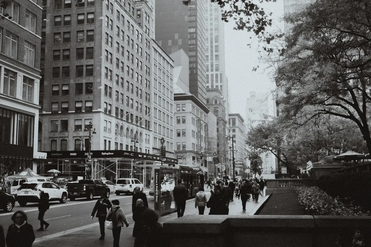 Bustling city street in New York with skyscrapers and pedestrians.